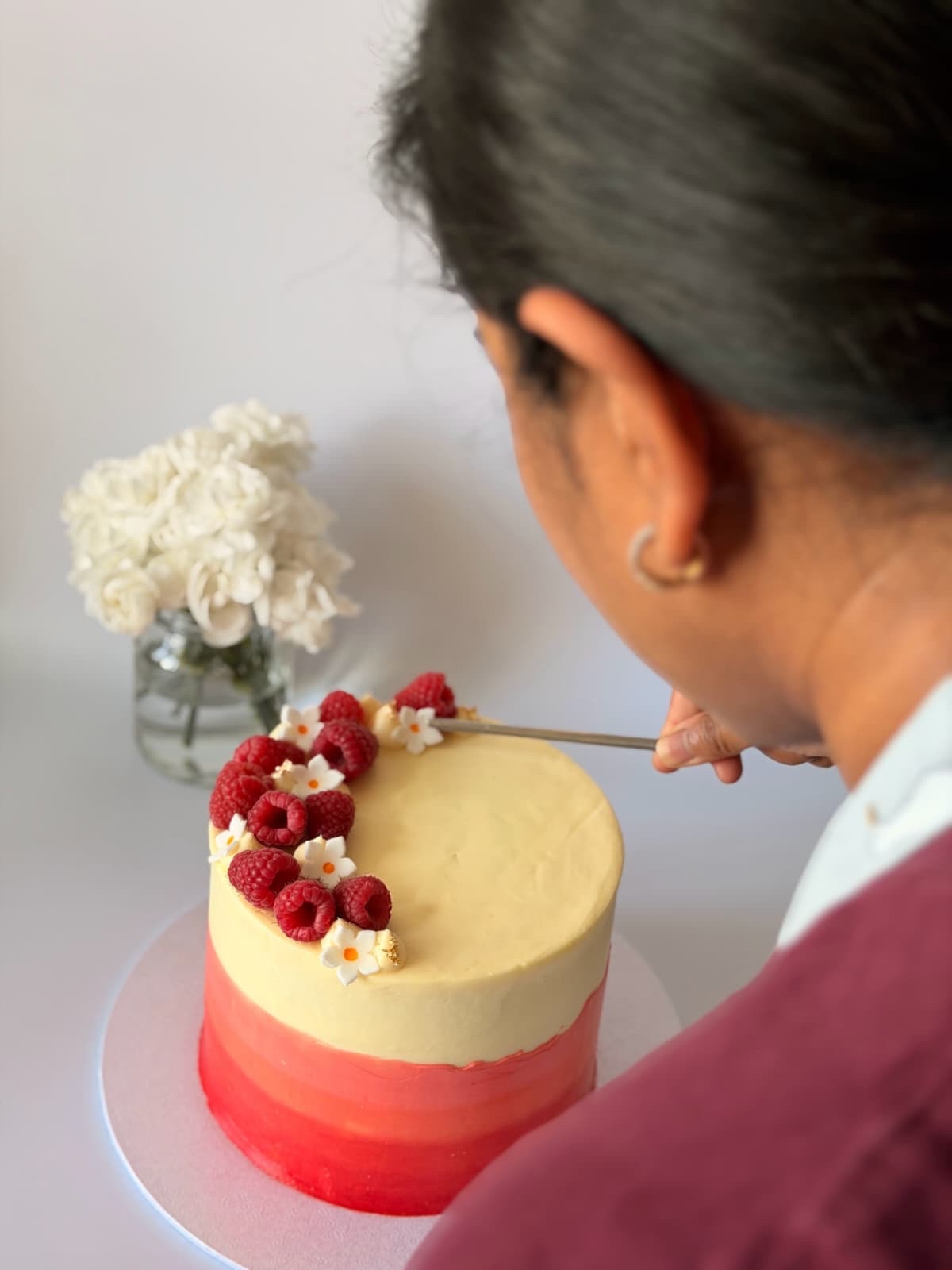 The chef at AIKA Patisserie adding the final details to a celebration cake